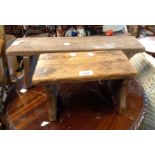 A small old rustic pine stool, set on shaped standard ends - sold with another rustic stool and an