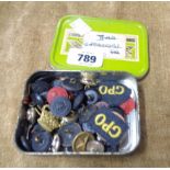 A tin containing a quantity of old buttons and patches including GPO, British Rail, etc.