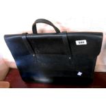 A vintage black leather satchel style briefcase