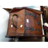 A late Victorian walnut slope fronted coal box with brass handles and strap hinges