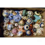 A box containing a large quantity of assorted ceramic lids