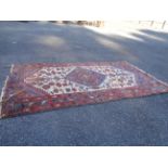 An old handmade rug witrh central diamond and multicoloured floral designs - wear - 1.85m x 1m