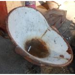 An antique metal hip bath with remains of original paint