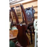 A pair of Victorian mahogany shield back hall chairs, set on turned front legs