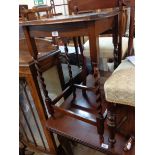 A 1920's polished oak occasional table, set on barley twist supports