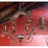 A decorative wrought iron and brass painted two branch electric ceiling lamp in the Gothic Revival