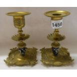 A pair of Victorian cast brass decorative candlesticks with pierced feet, ceramic stem and removable