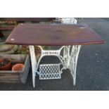 A table made from a Singer cast iron treadle sewing machine base