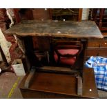 A 94cm old stained wood rustic side table with shaped top, set on bracketed standard ends