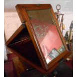A Victorian mahogany campaign style travelling mirror with folding ratchet action