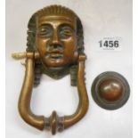 A Victorian cast brass door knocker and fittings with Egyptian head holder and original strike