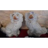 A pair of Victorian Staffordshire comforter spaniels with painted decoration and gilt highlighting