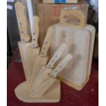 A modern pine kitchen knife block - sold with a set of wooden chopping boards and stand