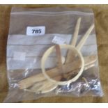 A bag containing a quantity of collectable items including carved bone, letter opener, etc.