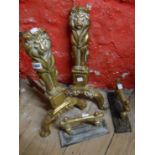 A pair of brass lion form fire dogs (one with arm missing) - sold with another cast iron and brass