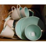 A box containing a quantity of Poole Pottery dinnerware in the green and beige colourways