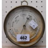 A small antique brass cased sedan style barometer with temperature scale and aneroid works - glass