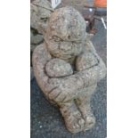 A concrete seated troll