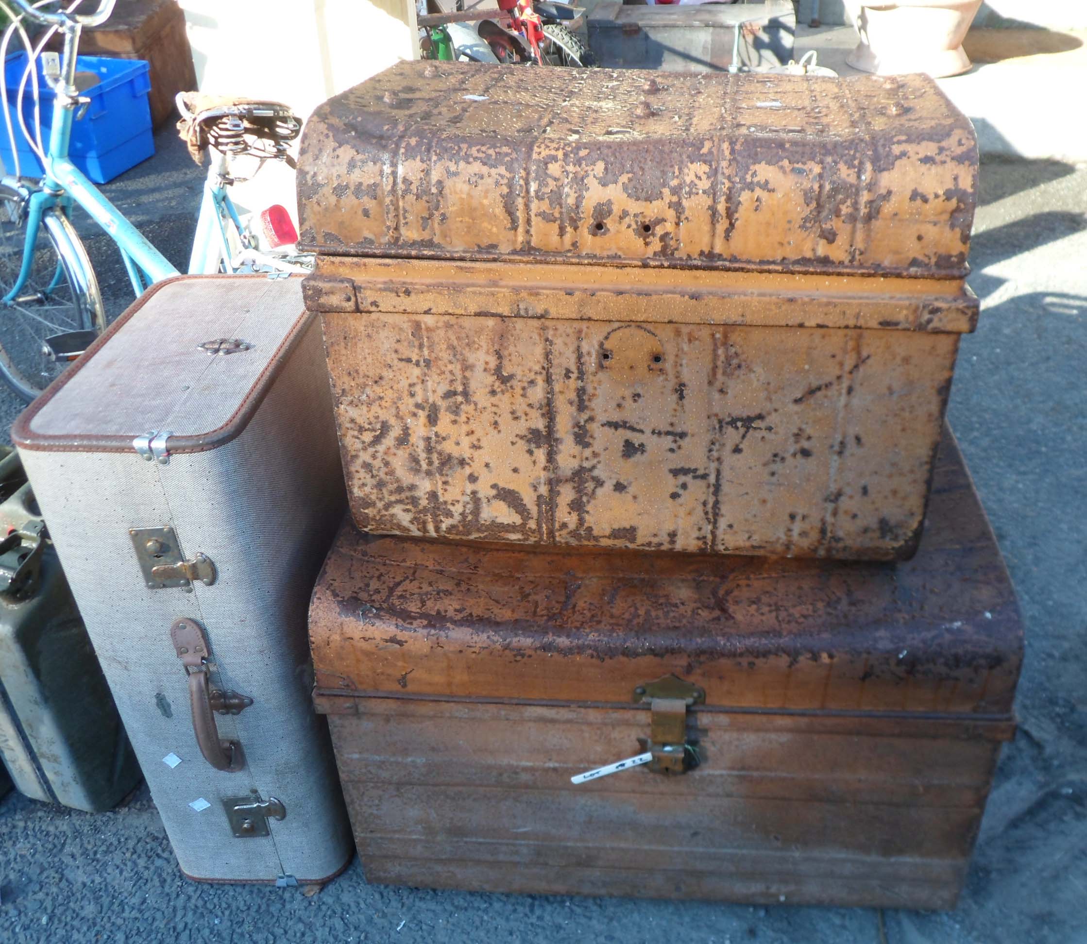 Two old tin trunks and an Overpond fibreboard suitcase