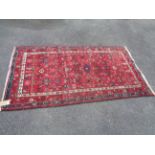 A vintage handmade rug with floral design and decorative border - 2m x 1.1m
