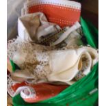 A bag containing a small quantity of textiles including crochet work tray cloths, etc.