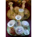 An Edwardian ceramic dressing table set comprising trinket boxes, candlesticks, ring tree, hat pin