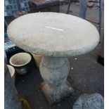 A large concrete garden pedestal table