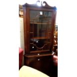 A reproduction mahogany corner cabinet with glazed top over cupboard, set on swept feet