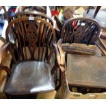 A harlequin set of four antique wheel back elbow chairs with moulded solid elm seats, set on