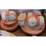 A quantity of Royal Doulton commercial tableware with pink banded decoration and gilt monogram H.G.