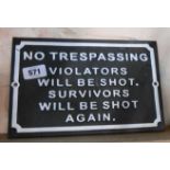 A modern painted cast metal No Trespassing sign