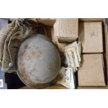 A box containing a quantity of WWII collectable items comprising helmet, gas mask in bag, two