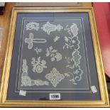 A gilt framed picture made from applied samples of old lace work