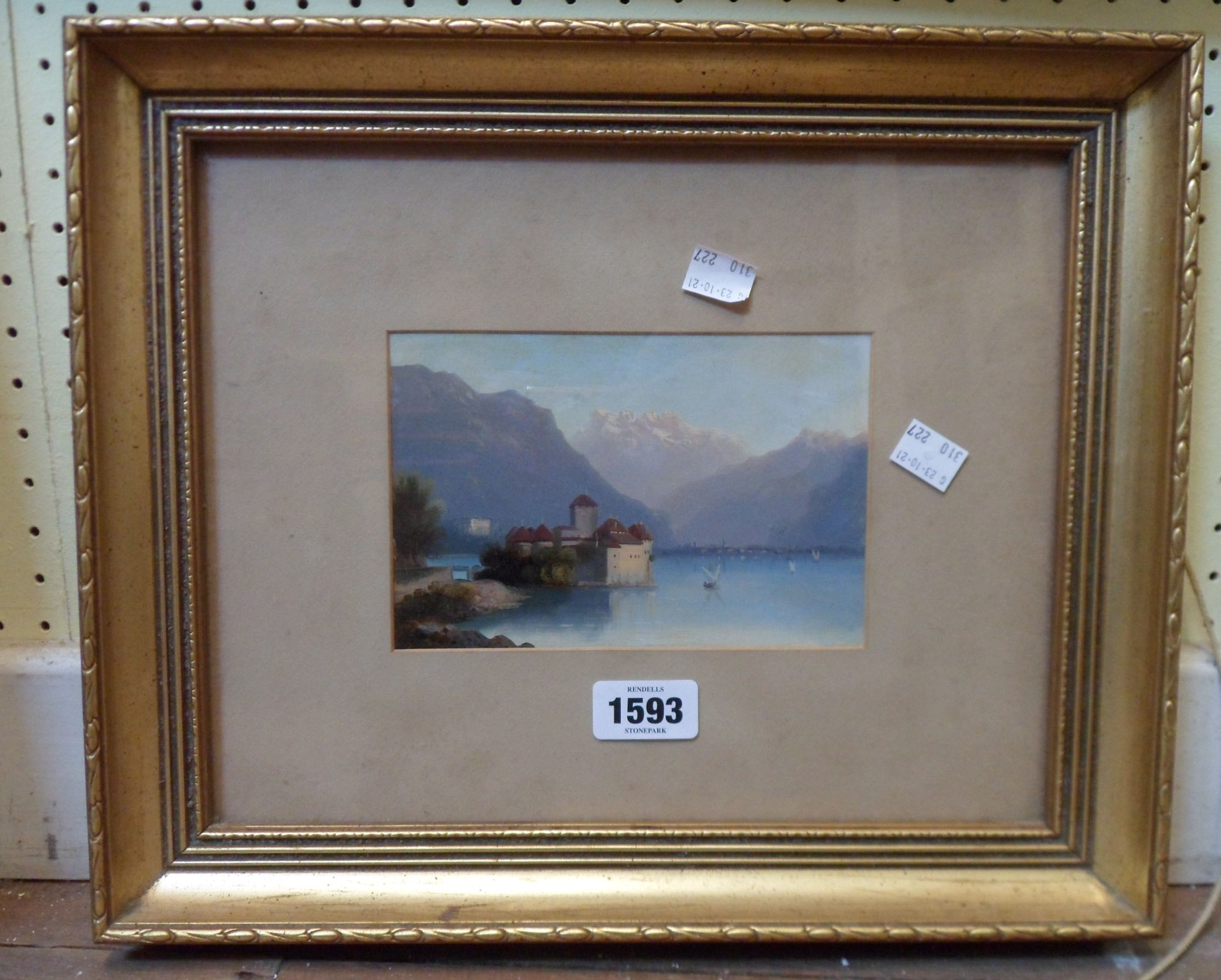 A small gilt framed oil on card, depicting a Swiss lake view with buildings and mountains in