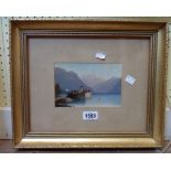 A small gilt framed oil on card, depicting a Swiss lake view with buildings and mountains in