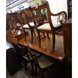 A reproduction mahogany draw-frame extending dining table with single leaf and applied metal bosses,