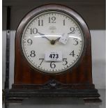 An early 20th Century mahogany cased mantle timepiece with orginal Synclock dial and replacement