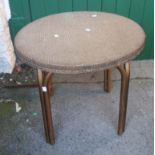 A mid Century Lloyd Loom style basketweave table with tubular legs and gold paint finish