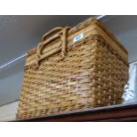 An old wicker picnic hamper with fitted interior