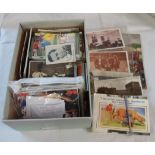 A shoe box containing a collection of Edwardian and later postcards including pop stars, topographic