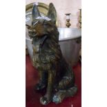 A cast brass figurine of a seated German Shepherd