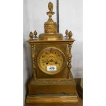 A late Victorian gilt brass cased salon table clock with cast bust to top, flanking pillars and