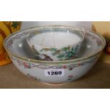A large antique Chinese export porcelain bowl decorated with enamel floral swags and frieze design -
