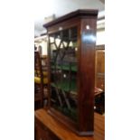 A 67cm late Georgian mahogany wall hanging corner cabinet with later lined interior enclosed by an