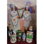 A large Victorian Staffordshire flat back figurine depicting musicians - sold with a pair of