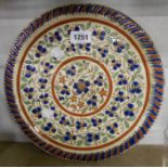 A Thoune pottery (Switzerland) charger decorated with a sgrafitto floral pattern highlighted in