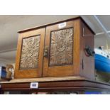 An Edwardian oak smoker's cabinet with lift lid and double fronted doors - with two associated