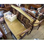 An Edwardian ornate inlaid mahogany framed three piece salon suite comprising a 1.26m settee with