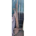 A collection of antique and later garden tools including Devon shovel, rake, fork, etc.