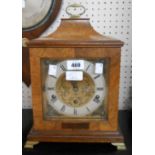 A figured walnut cased bracket style table clock with decorative dial and Mappin & Webb, London